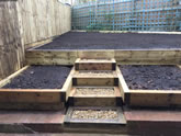 New garden landscape project including the construction of garden steps, flowerbeds and garden decking